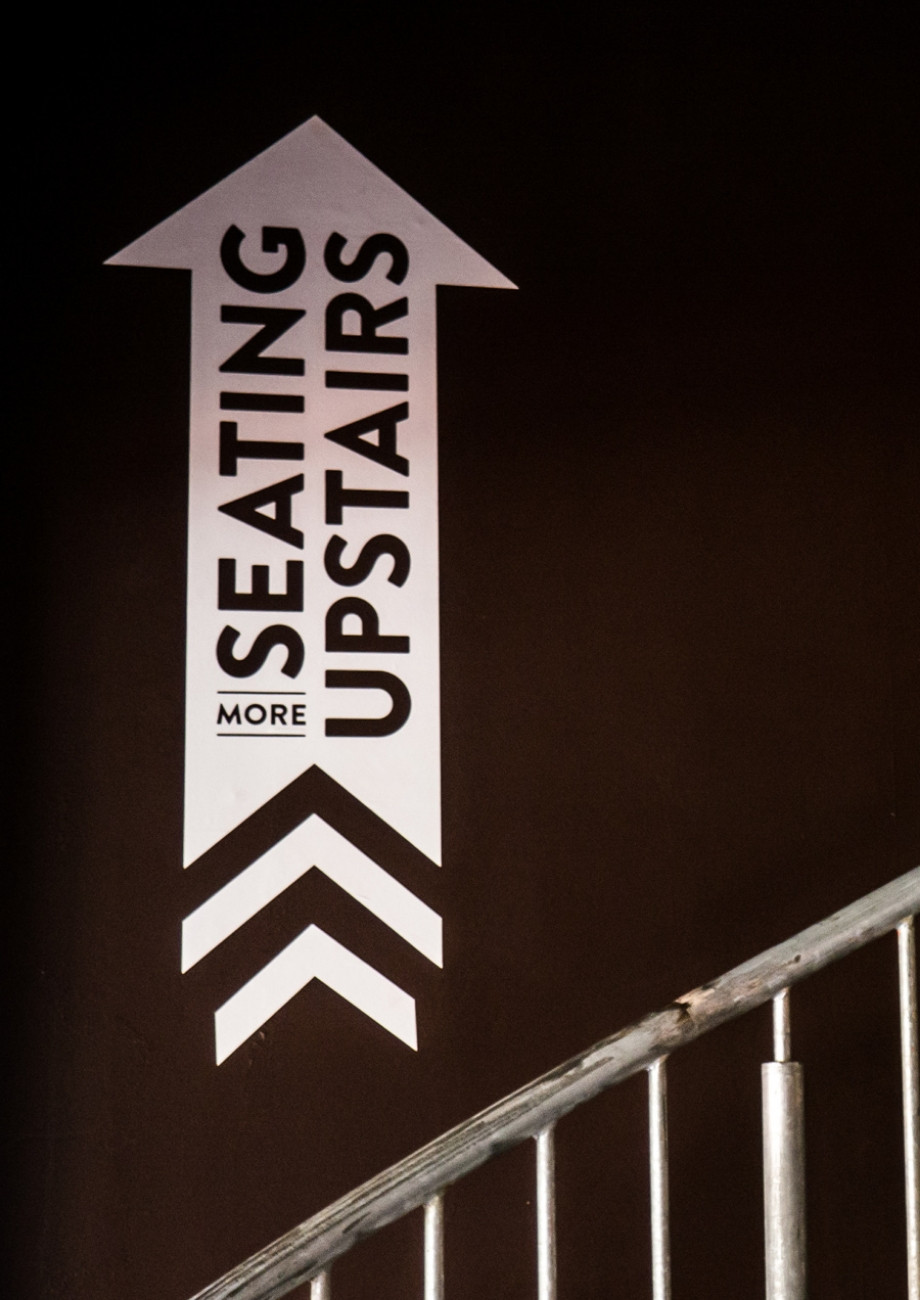Seating upstairs sign design by Root Studio